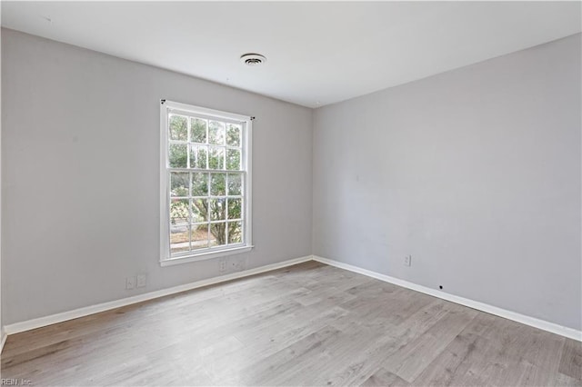 empty room with light hardwood / wood-style flooring and a healthy amount of sunlight