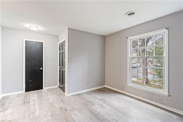 spare room featuring light hardwood / wood-style flooring