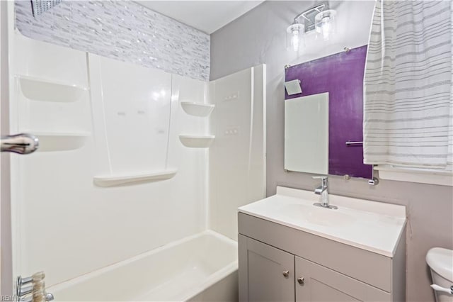 full bathroom featuring vanity, bathtub / shower combination, and toilet