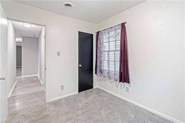 unfurnished bedroom featuring light colored carpet