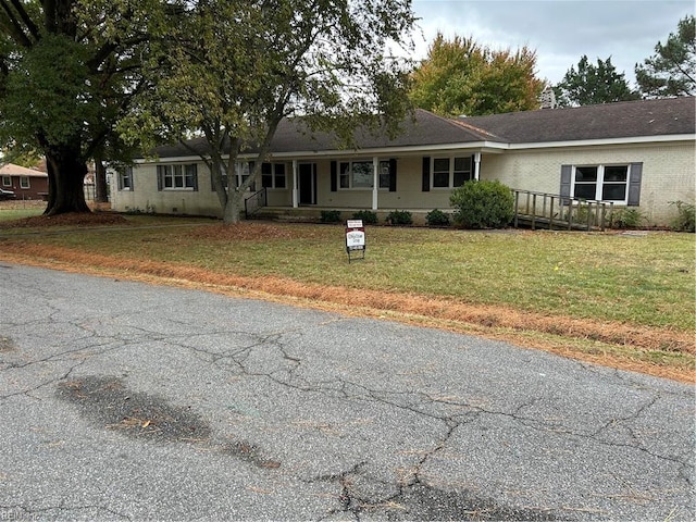 ranch-style home with a front lawn