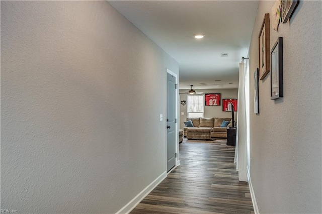 hallway with dark wood-type flooring