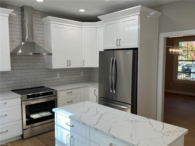 kitchen featuring white cabinetry, wall chimney exhaust hood, dark hardwood / wood-style floors, and appliances with stainless steel finishes