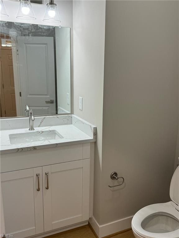 bathroom with vanity and toilet