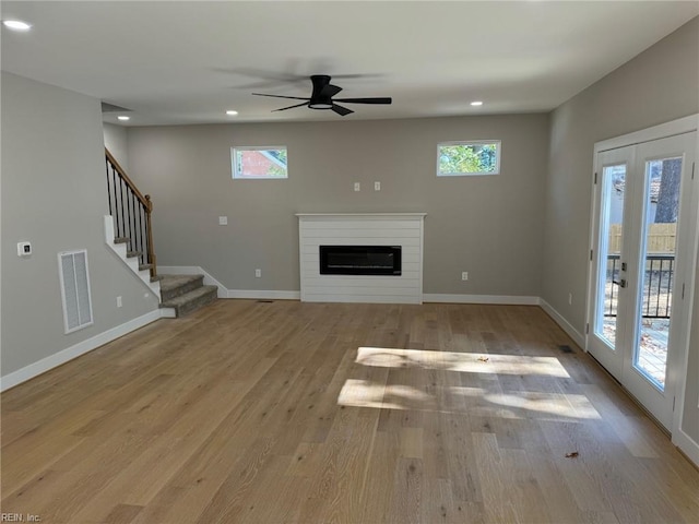 unfurnished living room featuring light hardwood / wood-style flooring and ceiling fan