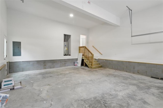 garage featuring electric water heater and electric panel