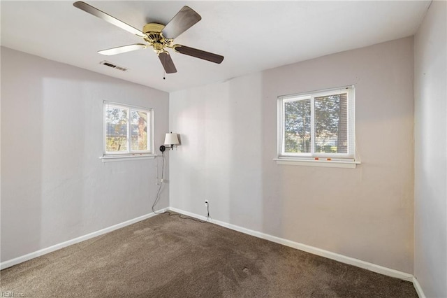 spare room featuring carpet flooring and ceiling fan