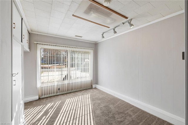 carpeted spare room featuring crown molding