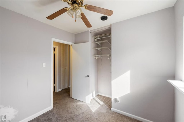 unfurnished bedroom with ceiling fan, carpet floors, and a closet