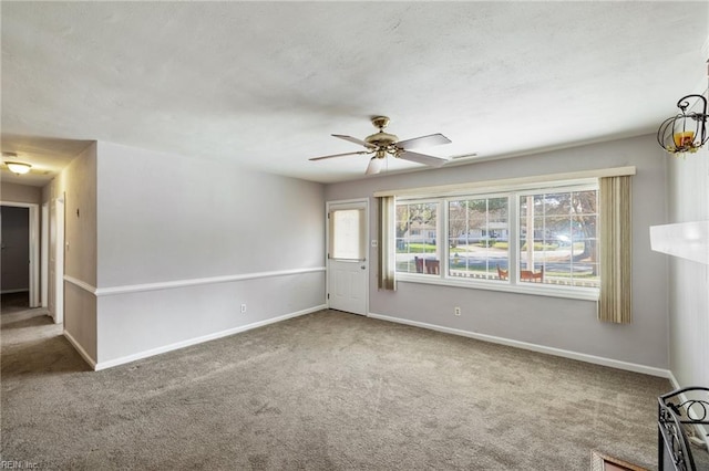 carpeted empty room featuring ceiling fan