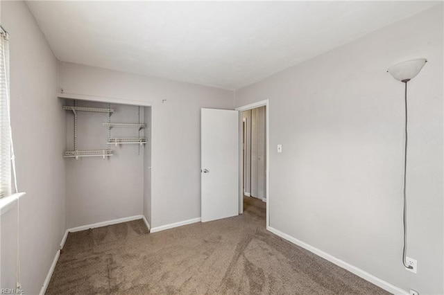 unfurnished bedroom with a closet and carpet