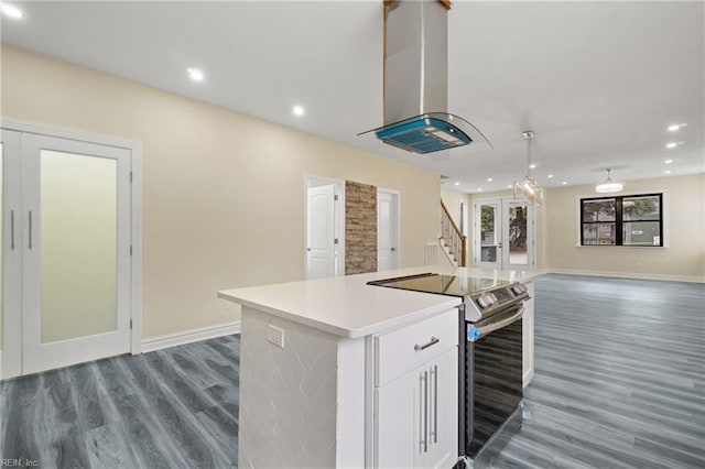 kitchen featuring stainless steel range with electric stovetop, a kitchen island, dark hardwood / wood-style flooring, white cabinetry, and island exhaust hood