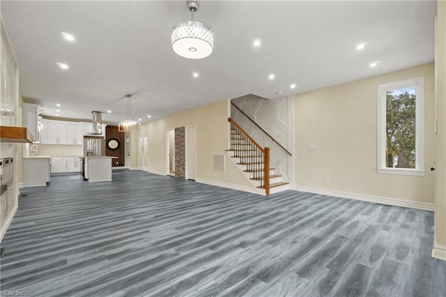 unfurnished living room with dark wood-type flooring