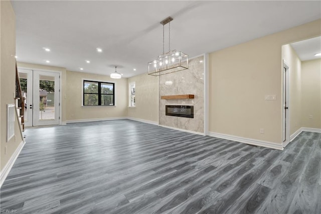 unfurnished living room featuring a fireplace and dark hardwood / wood-style flooring