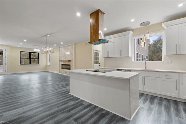 kitchen featuring island exhaust hood, white cabinets, and a kitchen island