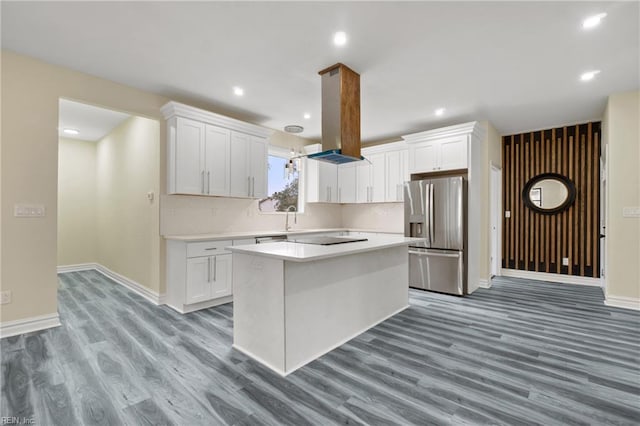 kitchen with hardwood / wood-style flooring, white cabinetry, a kitchen island, and stainless steel fridge with ice dispenser