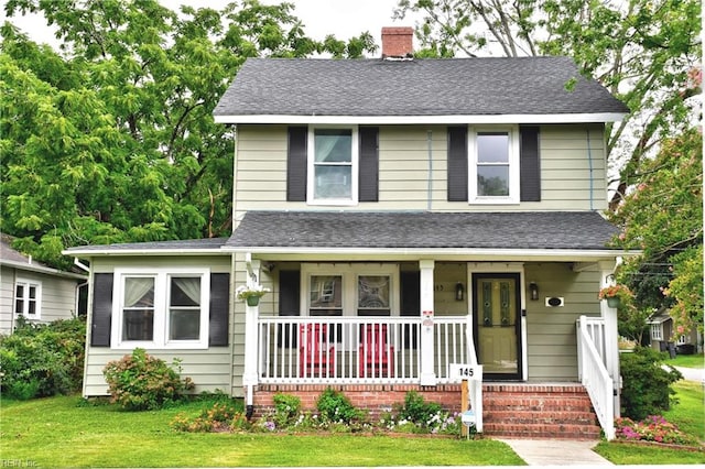 view of front of home featuring a porch and a front yard