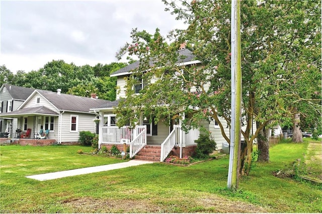 view of front of property featuring covered porch and a front yard