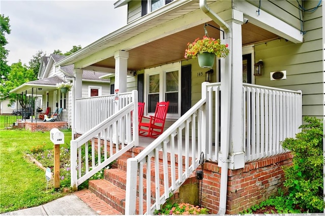 view of exterior entry with a porch