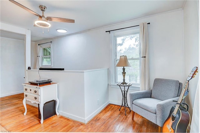 sitting room with ceiling fan and light hardwood / wood-style floors