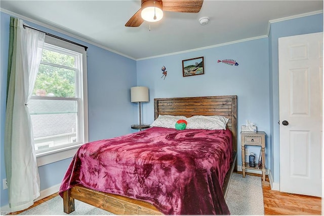 bedroom with ceiling fan, light hardwood / wood-style floors, and crown molding