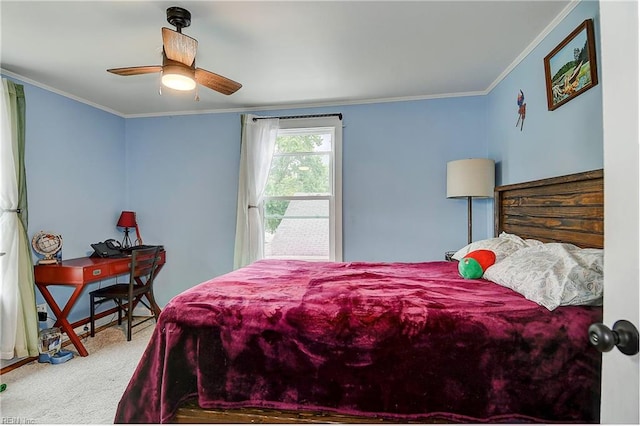 carpeted bedroom featuring ceiling fan and crown molding