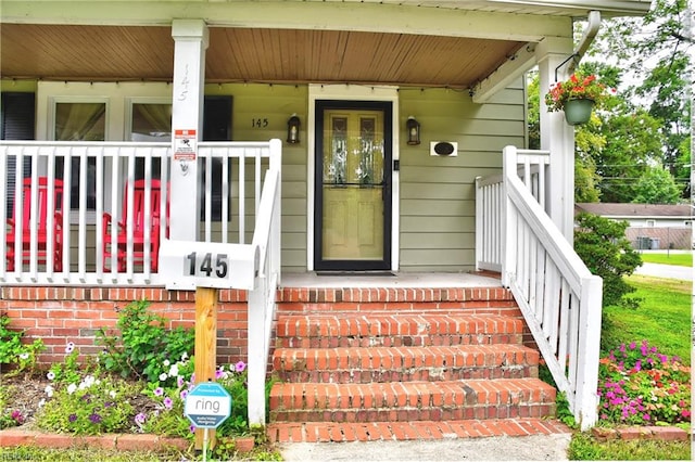 property entrance with covered porch