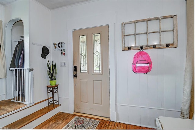 entrance foyer featuring light wood-type flooring and crown molding