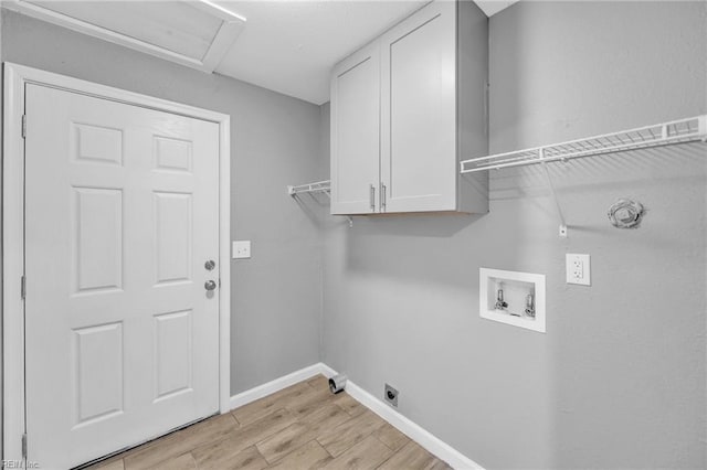 laundry area featuring washer hookup, cabinets, hookup for an electric dryer, gas dryer hookup, and light hardwood / wood-style floors