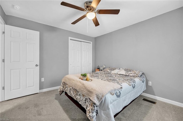 bedroom featuring ceiling fan, a closet, and light colored carpet