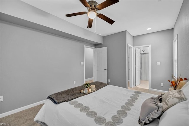 bedroom featuring ceiling fan, light colored carpet, and ensuite bathroom