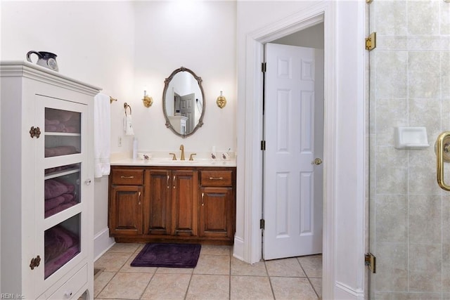 bathroom featuring tile patterned flooring, vanity, and walk in shower