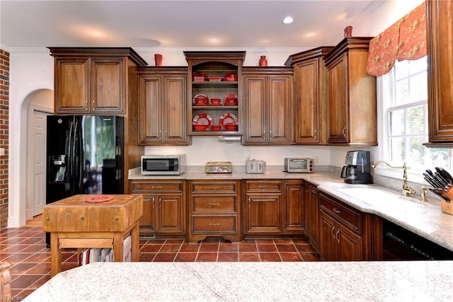 kitchen featuring crown molding, sink, and black appliances