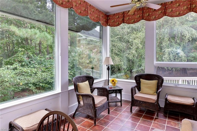 sunroom / solarium featuring ceiling fan