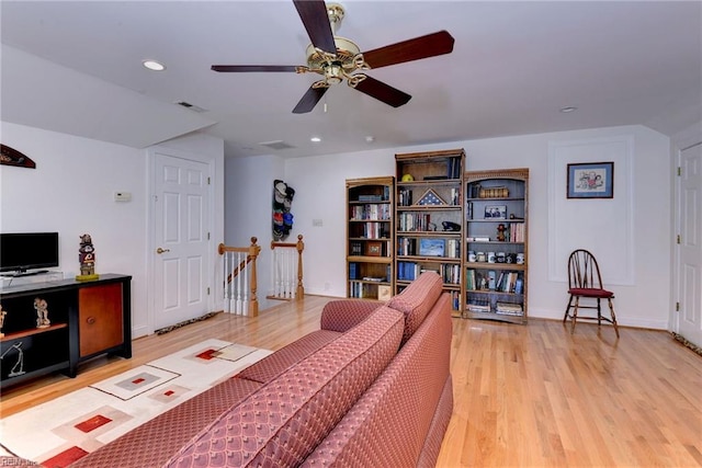 living room with ceiling fan and light hardwood / wood-style floors