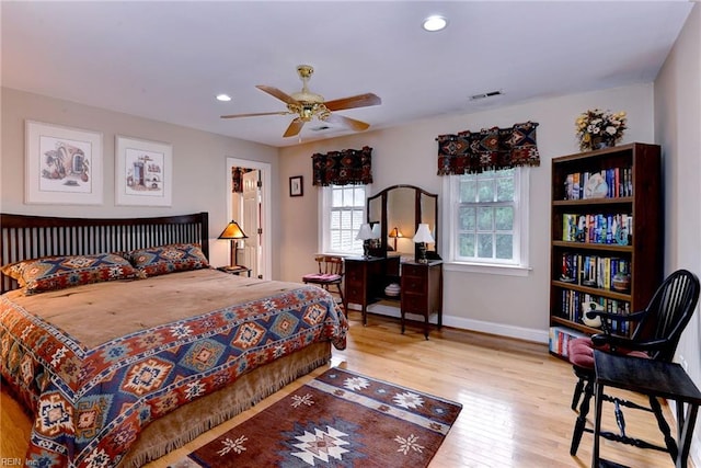 bedroom featuring multiple windows, ceiling fan, and light wood-type flooring