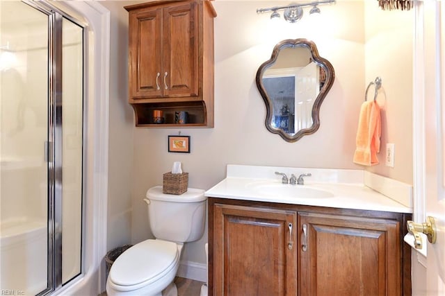 bathroom with vanity, toilet, and walk in shower