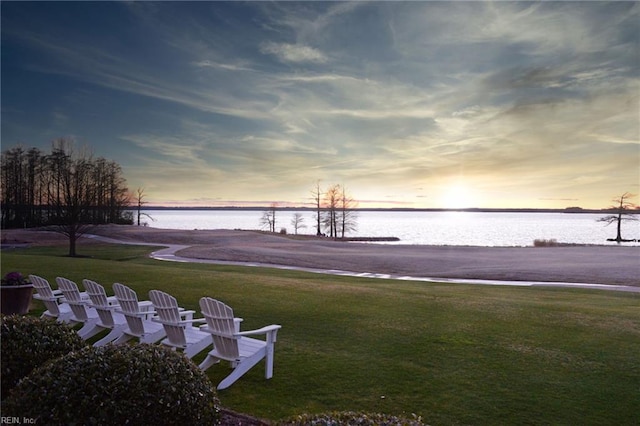 view of community with a water view and a lawn