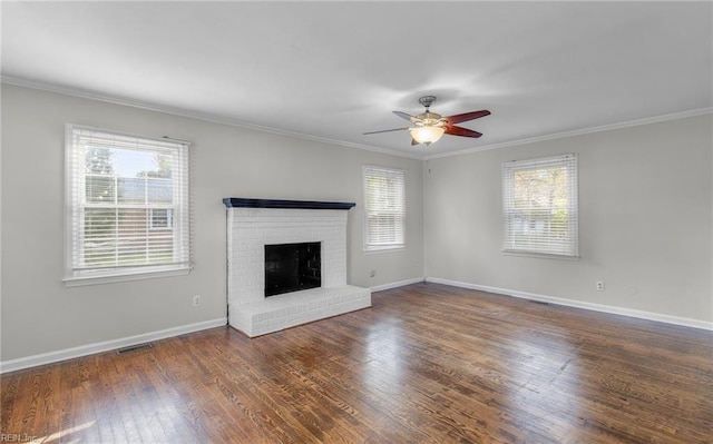 unfurnished living room with plenty of natural light, dark hardwood / wood-style floors, and ceiling fan