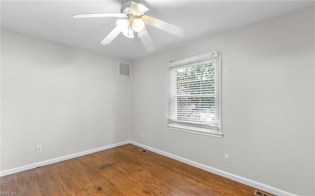 spare room with hardwood / wood-style flooring and ceiling fan