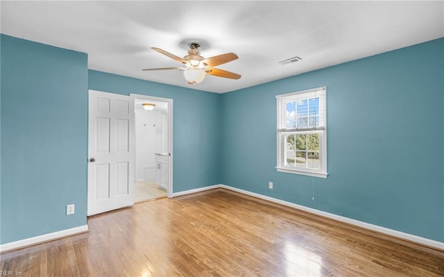 empty room featuring ceiling fan and light wood-type flooring