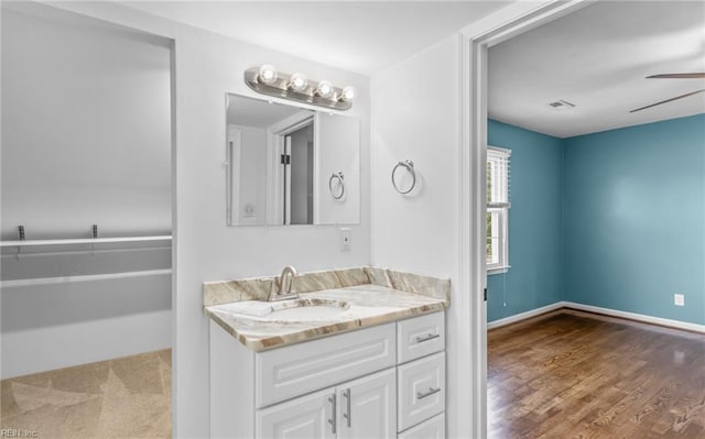 bathroom featuring hardwood / wood-style floors, vanity, and ceiling fan