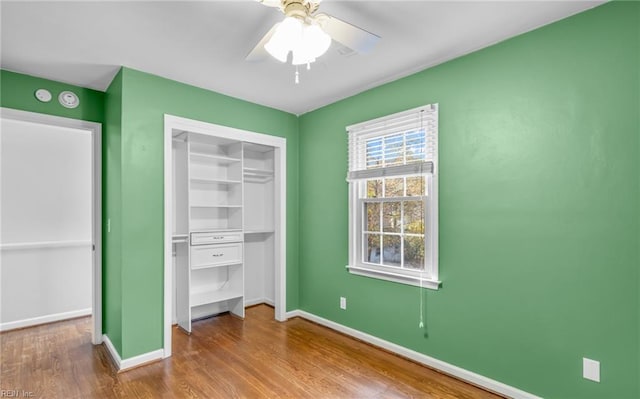 unfurnished bedroom with ceiling fan, light hardwood / wood-style floors, and a closet