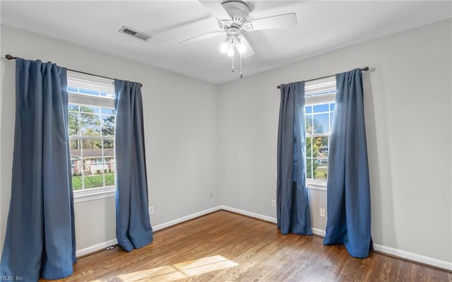 spare room featuring hardwood / wood-style flooring and ceiling fan