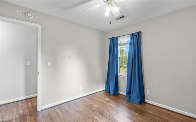 empty room with ceiling fan and hardwood / wood-style floors