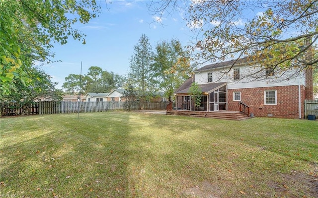 view of yard with a sunroom and a wooden deck