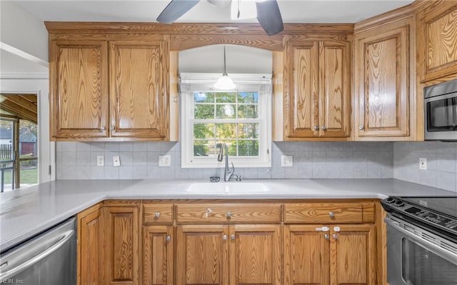 kitchen featuring ceiling fan, sink, appliances with stainless steel finishes, and tasteful backsplash