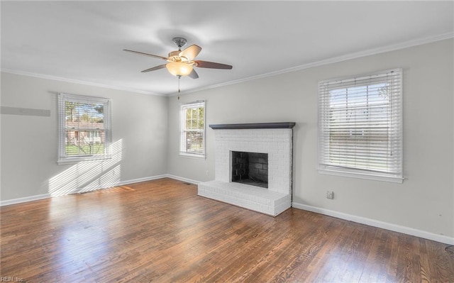 unfurnished living room with a fireplace, ornamental molding, ceiling fan, and dark wood-type flooring