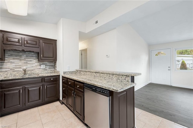 kitchen featuring dishwasher, kitchen peninsula, and lofted ceiling