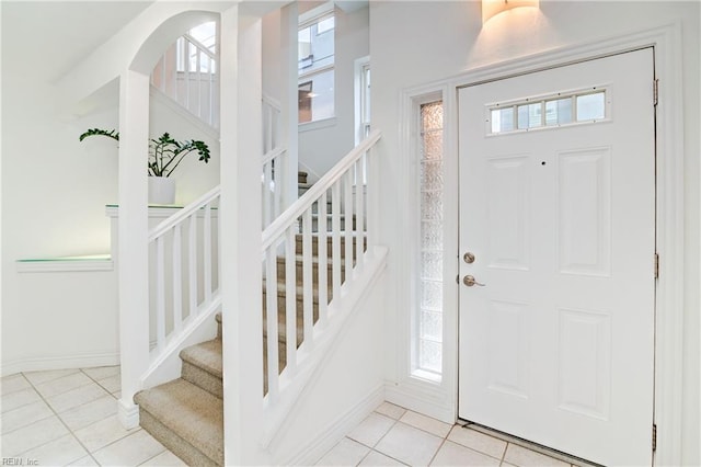 entryway with light tile patterned flooring